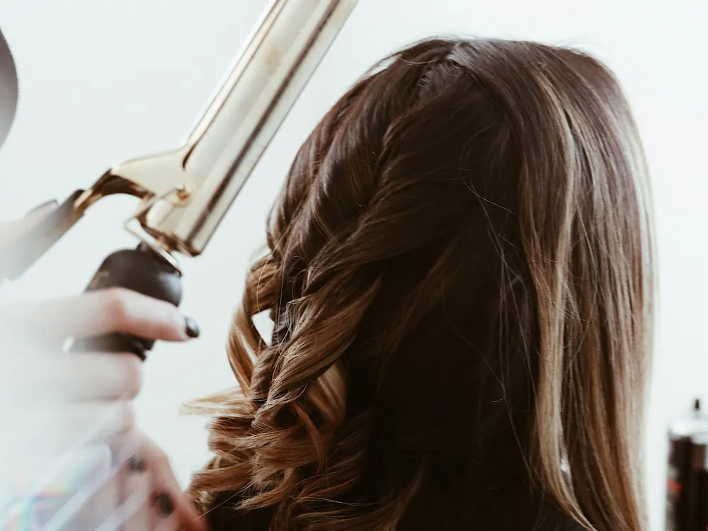 Cabelo sendo finalizado com modelador